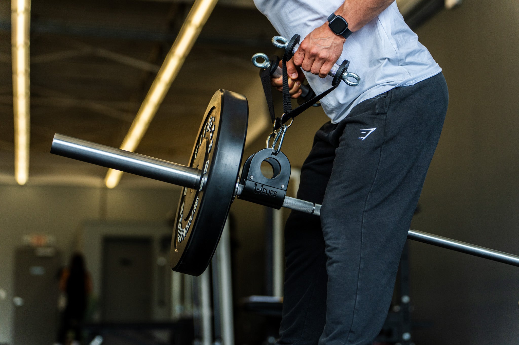 Lifter rowing with Smile Handles clipped to a loaded barbell via the U Clip